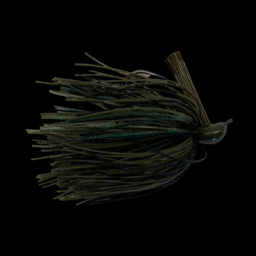 An olive green and black soft plastic fishing lure with a skirt, photographed on a light gray marble-patterned surface.