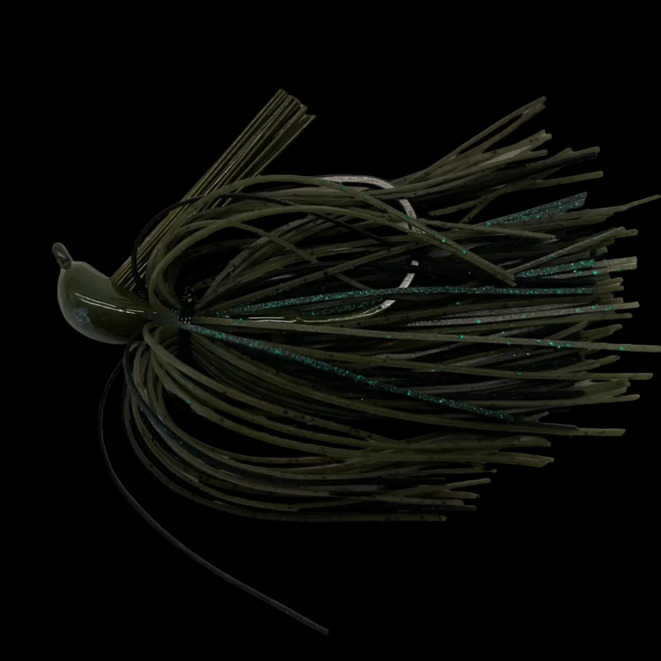 An olive green soft plastic fishing lure with a wide skirt made of dark strands and subtle teal-green glitter, shown against a solid black background.