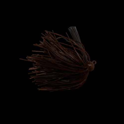 A dark brown soft plastic fishing lure with a single hook and skirt, placed on a light gray marble-patterned surface.